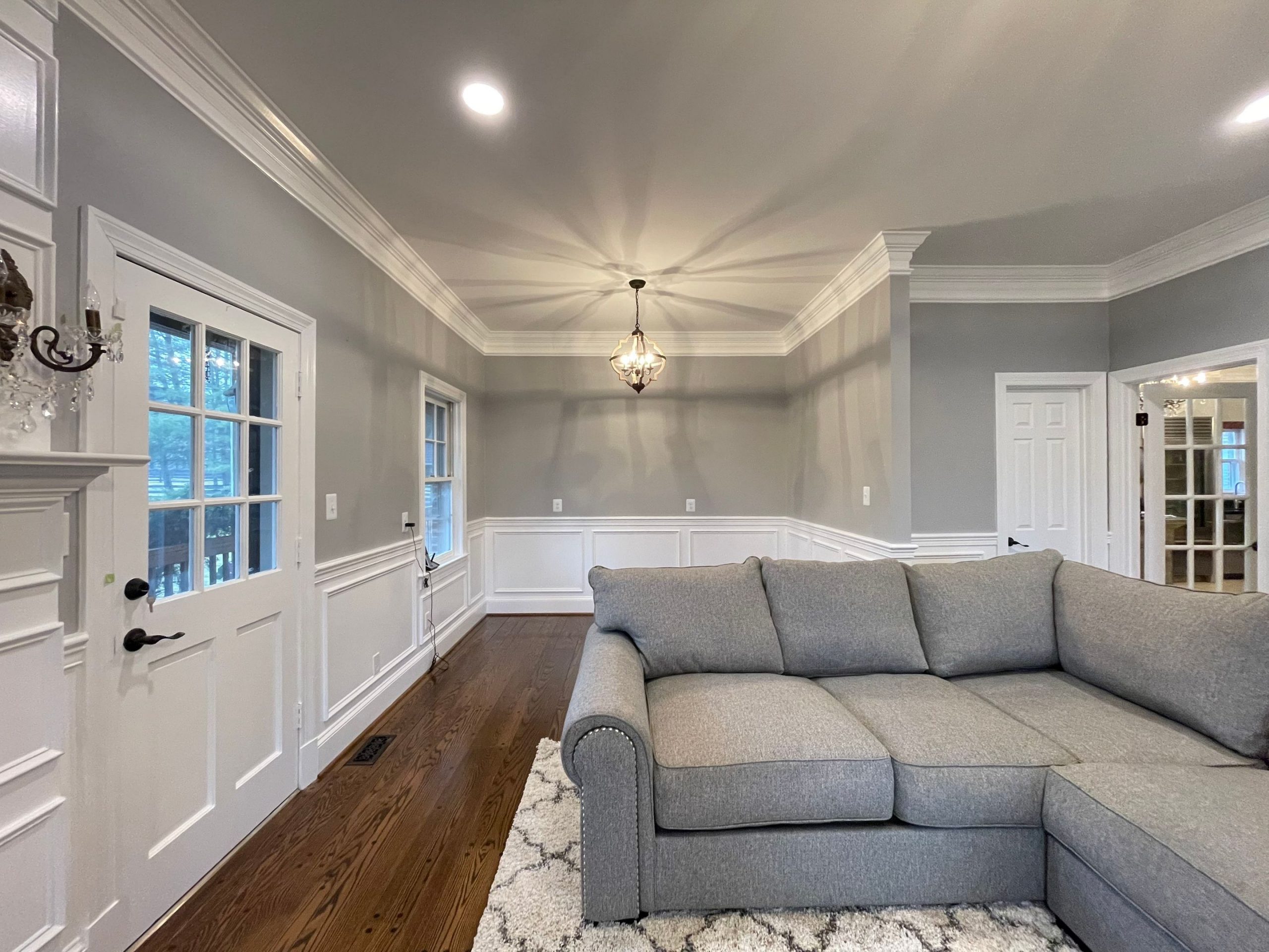 Professionally painted interior living room with gray walls and white trim in Houston TX